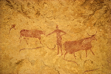 Painting with herdsman tending cattle on cave wall, Tassili Plateau, Algeria, North Africa, Africa