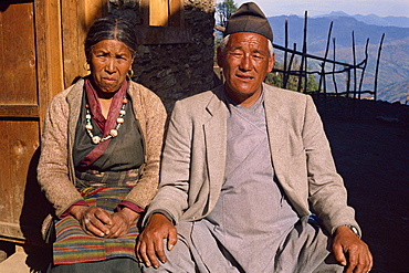 Portrait of an elderly Sherpa couple in traditional clothing, sitting outdoors, look at the camera, at Solu Khumbu, Nepal, Asia