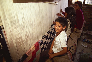 Young children weaving carpets for up to 16 hours a day in carpet factories, Jawlikhel, Kathmandu, Nepal, Asia