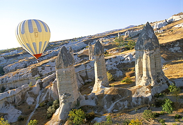 Hot air ballooning over rock formations, Cappadocia, Anatolia, Turkey, Asia Minor, Asia