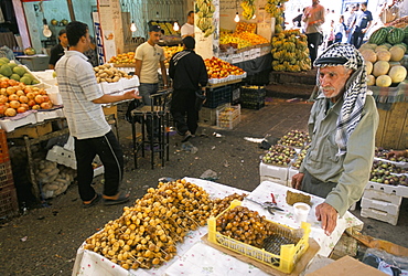 Man selling dates in downtown vegetable market, Amman, Jordan, Middle East