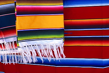 Striped woven rugs in vibrant primary colours for sale in Mexico, North America