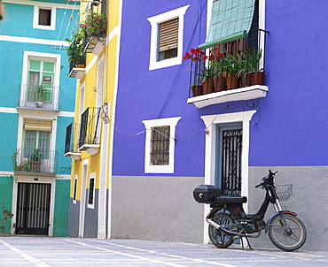 Old motorcycle outside a purple painted house in Villajoyosa, in Valencia, Spain, Europe