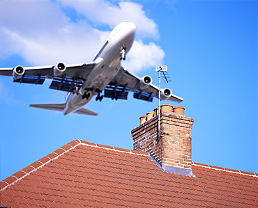 Low-flying aircraft over rooftops near London Heathrow Airport, Greater London, England, United Kingdom, Europe