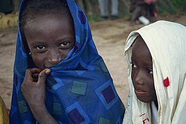 Head and shoulders portrait of two young Gambian children, one looking at the camera, Gambia, West Africa, Africa