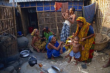 Families in the area outside their shack in a slum in the city of Dhaka (Dacca), Bangladesh, Asia