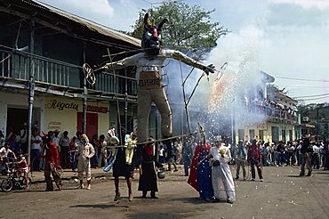 People carrying large effigy through the streets during the Easter festival ritual, Ciudad de Santos, Mexico, North America