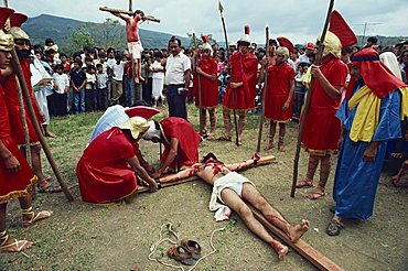 Men in Roman costume and men on crosses during a crucifixion re-enactment at Easter in Ciudad Santos, Mexico, North America