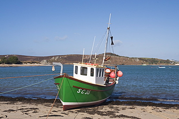 Fishing boat on Bryer with Tresco in background, Isles of Scilly, United Kingdom, Europe