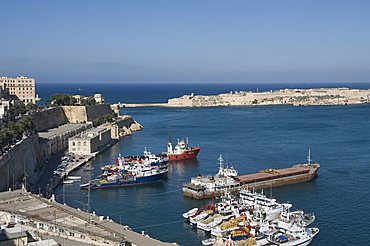 View of the Grand Harbour with fishing boats taken from Barracca Gardens, Valletta, Malta, Mediterranean, Europe