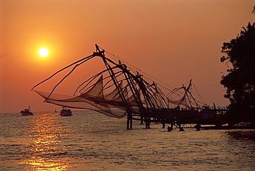 Chinese fishing nets at sunset, Fort Cochin, Kerala state, India, Asia