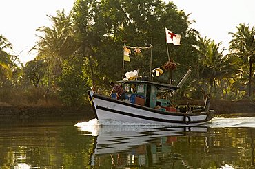 Fishing boats on backwater near Mobor, Goa, India, Asia