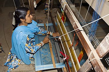 A woman weaving at one of the cooperatives in an area that is famous for its saris, Maheshwar, Madhya Pradesh state, India, Asia