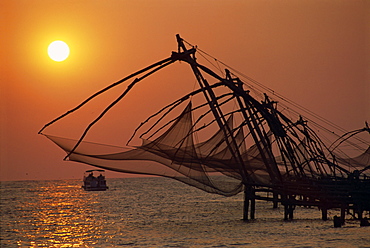 Fishing nets at sunset, Cochin, Kerala state, India, Asia