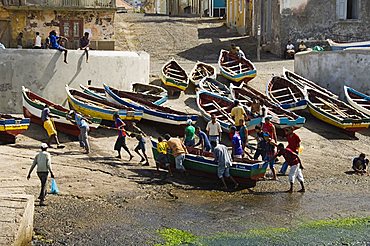 Fishermen taking boat out of water at the port of Ponto do Sol, Ribiera Grande, Santo Antao, Cape Verde Islands, Atlantic, Africa