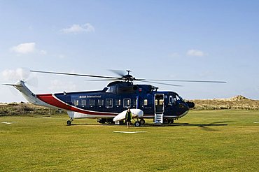 Helicopter at Tresco heliport, Tresco, Isles of Scilly, off Cornwall, United Kingdom, Europe