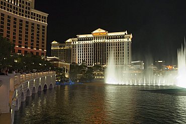 The Bellagio Hotel in forground with Caesar's Palace in background at night, Las Vegas, Nevada, United States of America, North America