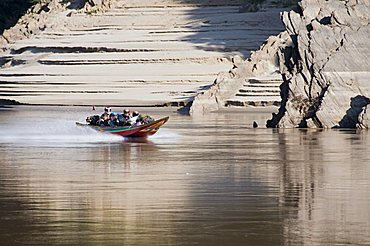 Long tailed boats ferrying passengers down the Mekong River from Thailand to Luang Prabang, Laos, Indochina, Southeast Asia, Asia