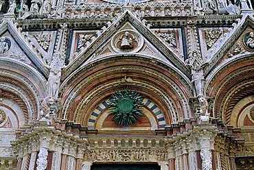 Gothic detail on the facade of the Duomo (Cathedral), including the sun symbol, Siena, UNESCO World Heritage Site, Tuscany, Italy, Europe