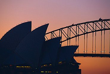 Sydney Opera House and Harbour Bridge silhouetted together at sunset, Sydney, New South Wales,  Australia