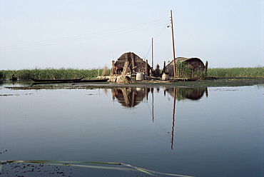 Reed houses and boat, Marshes, Iraq, Middle East