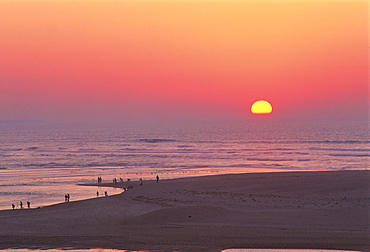 The beach and sea at sunset with yellow and purple sky, at Estremadura, Atlantic coast, Portugal, Europe