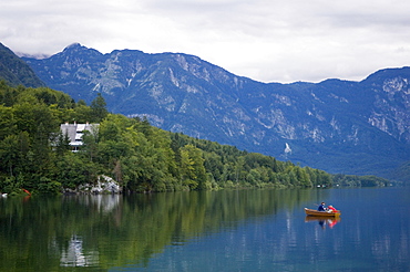 Couple fishing from a boat, Lake Bohinj, Slovenia, Europe