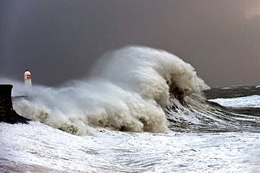 Huge waves crash against the harbour wall at Porthcawl, Bridgend, Wales, United Kingdom, Europe