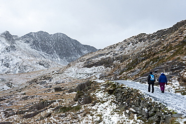 Hikers on the Miner's Track at base of Mount Snowdon in a wintry landscape in the Snowdonia National Park, Gwynedd, Wales, United Kingdom, Europe