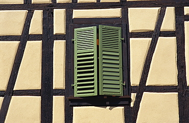 Detail of typical window with green shutters in timbered house in the old town of Ribeauville, Alsace, France, Europe