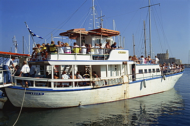 Tourist boat in Mandraki harbour, on the island of Rhodes, Dodecanese, Greek Islands, Greece, Europe