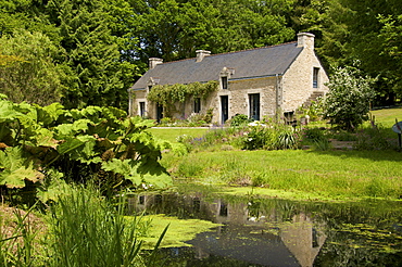 Ancient farm house and pond, granite walls and slate roof, Bubry village, near Hennebont, Morbihan, Brittany, France, Europe