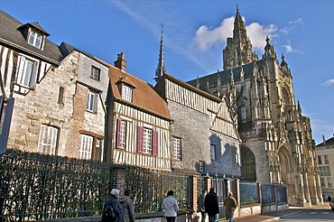 The west facade of the 15th century Notre Dame church, houses and tourists, Caudebec en Caux, Normandy, France, Europe