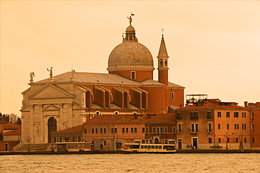 Il Redentore church dating from 1576, on Giudecca island, and Giudecca Canal with vaporetto, at sunset, Venice, UNESCO World Heritage Site, Veneto, Italy, Europe