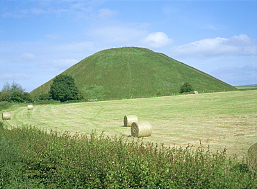 Baled hay in field below Silbury Hill, Wiltshire, England, United Kingdom, Europe