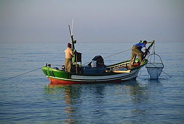 Fishermen in an open boat fishing for anchovies near Nerja off the coast of Andalucia (Andalusia), Spain, Mediterranean, Europe