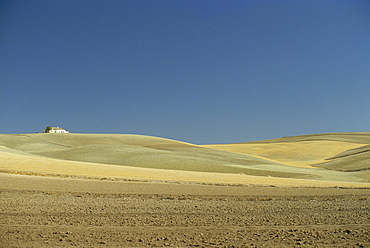 Landscape of a farmhouse and ploughed fields and clear blue sky, near Jaen, Andalucia (Andalusia), Spain, Europe