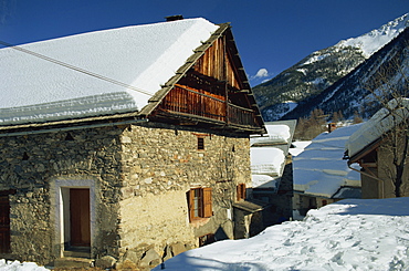 Houses covered in snow in the village of Nevache near Briancon, French Alps, France, Europe