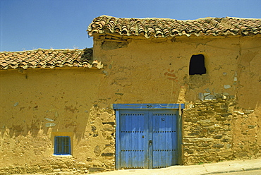 Exterior of an adobe house with a tile roof and blue door, Salamanca, Castile Leon (Castilla Leon), Spain, Europe