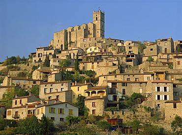 Christian church on the skyline and houses in the village of Eus, Languedoc Roussillon, France, Europe