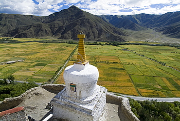 View over cultivated fields, Yumbulagung Castle, restored version of the region's oldest building, Tibet, China, Asia