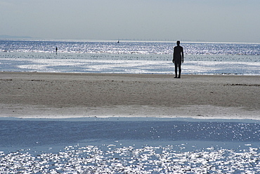 Two of the 100 men of Another Place, also known as the Iron Men, tatues by Antony Gormley, Crosby Beach near Liverpool, Merseyside, England, United Kingdom, Europe