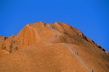 Tourists climbing Ayers Rock (Uluru), UNESCO World Heritage Site, Northern Territory, Australia, Pacific