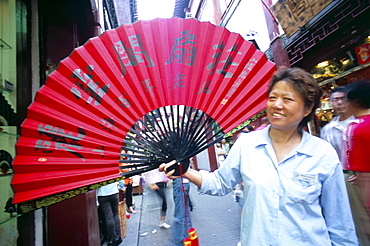 Woman holding large red fan, Tongli, Shanghai area, China, Asia