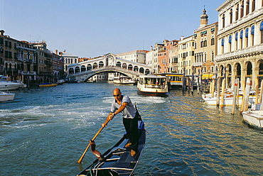 Gondolier and Rialto Bridge, Venice, Veneto, Italy, Europe