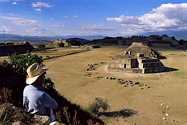 Tourist looking at the ruins of Monte Alban, UNESCO World Heritage Site, near Oaxaca, Mexico, North America