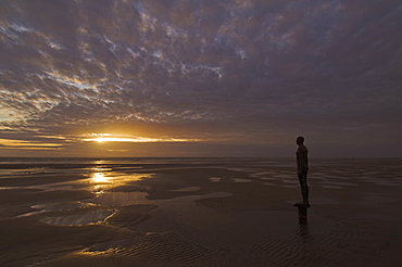 Another Place statues by artist Antony Gormley on Crosby beach, Merseyside, England, United Kingdom, Europe