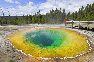 Female tourist on boardwalk by the Morning Glory Pool, Upper Geyser Basin, Yellowstone National Park, UNESCO World Heritage Site, Wyoming, United States of America, North America