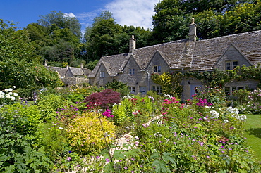 Traditional Cotswold stone cottages with colourful flower gardens, Bibury, Gloucestershire, Cotswolds, England, United Kingdom, Europe