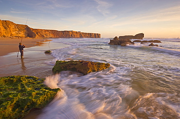 Fisherman on Tonal beach at sunset, blurred milky water, Sagres, Algarve, Portugal, Europe